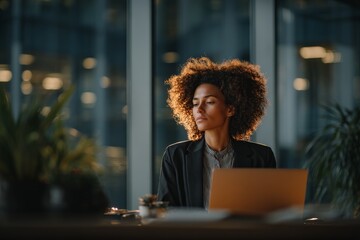 Poster - Professional woman working late in a modern office with natural light and plants