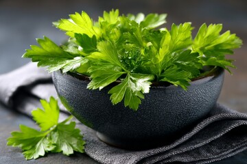 Poster - Fresh parsley in a dark bowl on a folded gray napkin ready for cooking or garnishing meals