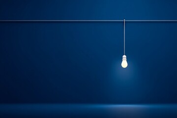 Aufkleber - Modern light bulb hanging from a wire against a dark blue background illuminating a minimalist space