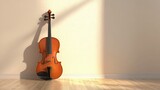 Violin leaning against a light-toned wall, providing a perfect base for copy or creative music design.