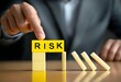 © Hridus - Businessman Preventing Risk Domino Effect with Blocks