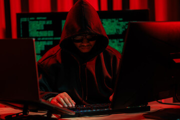 lone hacker in a dark glowing room hacking data for cyber theft, symbolizing digital crime and onlin