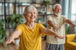 © whitestorm - A happy senior couple enjoying a healthy lifestyle with regular exercises together, doing stretching and smiling in their living room, staying active at home.