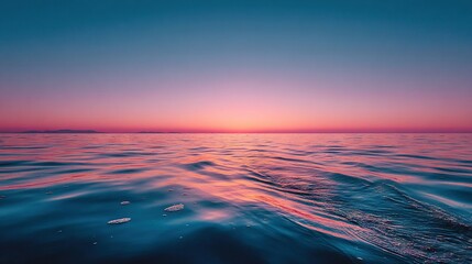 Wall Mural - a vast expanse of water, illuminated by an enchanting sunset, embraces the horizon, while a diminuti
