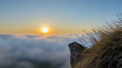 Poster - Sunrise Above the Clouds: A breathtaking vista unfolds as the sun majestically rises above a sea of clouds, casting a warm glow over the serene landscape.