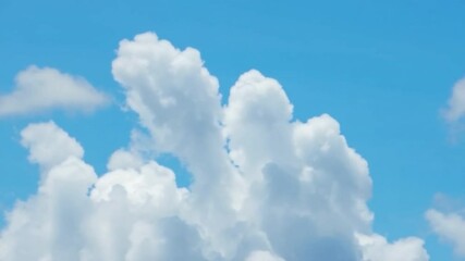 Poster - Heavenly Ascent: Capture the serenity of a sunlit sky adorned with billowy clouds, evoking a sense of freedom and boundless wonder. 