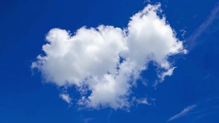 Poster - Cloud in the Sky: A fluffy white cloud floats gently against a brilliant blue sky, evoking a sense of serenity and tranquility, offering a picturesque scene of pure nature's beauty.