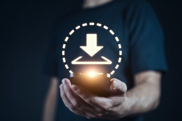 Poster - A person holding a glowing download icon in their hands against a dark background in a studio shot
