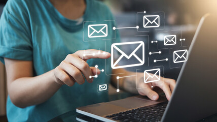 Poster - Person using laptop with email icons displayed for online communication and digital marketing strategy