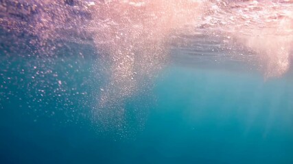 Poster - View of clear turquoise water from below with rising bubbles and sunlit surface creates tranquil underwater scene.