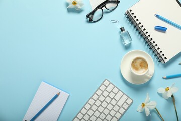Poster - Flat lay composition with stationery, coffee and flowers on light blue background. Space for text