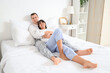 © Pixel-Shot - Young loving couple hugging in bedroom