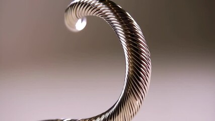 Poster - Elegant silver metal twisted and coiled rod with textured surface, studio shot on a neutral backdrop.