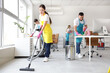 © Pixel-Shot - Team of young janitors cleaning in office