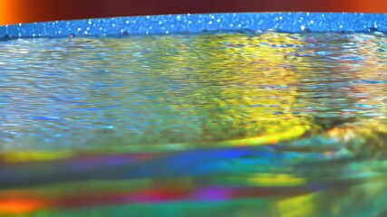 Poster - Abstract water surface with iridescent rainbow colors showing reflection and refraction patterns in light, shimmering background