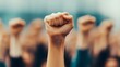 © pkproject - Protesters raise clenched fists at a rally, symbolizing civil resistance and collective voice.