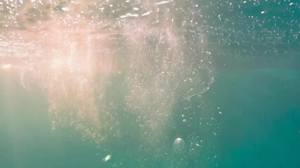 Poster - Submerged view of sunlit water surface with abundant bubbles and clear turquoise ocean backdrop creating a calming, dreamy underwater atmosphere.