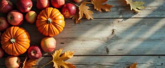 Poster - Autumn Still Life: Pumpkins, Apples, and Maple Leaves on Rustic Wooden Tabletop in Warm Sunlight