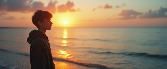 Poster - Contemplative teenager gazes at a scenic sunrise over the tranquil ocean, standing on the sandy beach, silhouetted against the vibrant sky