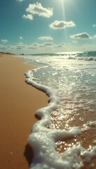Poster - Captivating beach scene: Waves gently caressing golden sand under a sunny sky, creating a tranquil seascape.