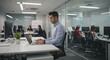 © SRD - Focused Young Professional Working on Laptop in Modern Office Environment. Collaborative Teamwork and Productivity Concept.