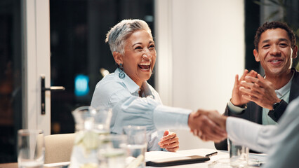 Poster - Handshake, applause and business people in meeting with success, and winning finance deal at night. Team, shaking hands and mature woman at financial seminar with celebration, achievement and funding
