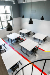 Poster - Modern office workspace featuring tables and chairs in a bright, minimalist design