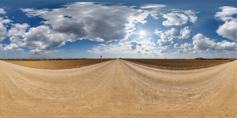 Wall Mural - hdri 360 panorama view on gravel road among fields with clouds in sky in equirectangular full seamle