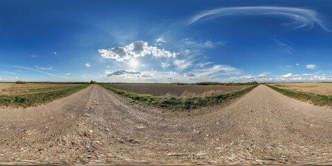 Wall Mural - hdri 360 panorama view on gravel road among fields with clouds in sky in equirectangular full seamle