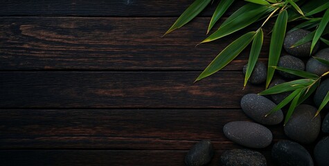 Poster - Dark wood background with smooth black stones and bamboo leaves.