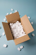 © Tetra Images - Open cardboard box filled with packing foam peanuts made of expanded polystyrene