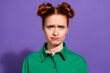 © deagreez - Portrait of a young red haired woman with a green shirt expressing a playful and humorous attitude against a vibrant purple background