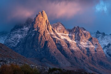 Poster - Majestic mountain peak illuminated by golden light during a picturesque sunrise in a remote wilderness area