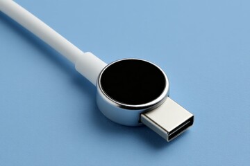 Poster - Modern magnetic charger with USB-C connector on a blue background for efficient device charging
