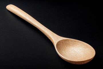Poster - Wooden spoon on a black background highlighting craftsmanship and natural materials in kitchen utensils