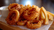© suvijak - Crispy Onion Rings and Golden Fries Served on a Wooden Platter