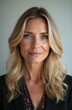 © Maryna - Portrait of smiling middle aged woman with blond wavy hair. Lady with blue eyes, soft skin, natural makeup looks directly into camera. Studio photo, pro fashion shot, business concept, beauty,