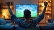 © Maryna - Man watches football match home living room. Guy celebrates goal victory supporting favorite team. Person enjoys leisure time entertainment. Emotionally cheering fans at TV screen.