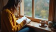 © Maryna - Young woman writes journal, reflects thoughts near window, cup tea nearby. Cozy scene encourages contemplation emotion mindfulness serenity. Ideal for wellness lifestyle content, meditation, calm,
