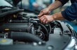 © Maryna - Car mechanic man repairing car engine. Hands fixing machinery in auto repair shop. Vehicle car maintenance, mechanical service, auto mobile inspection, vehicle overhaul. Technician checking