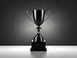 © Pattra - Elegant Black Trophy on Dark Background with Smooth Lighting