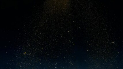 Poster - Swirling golden glitter particles floating in a dark space, illuminated with a glowing effect, creating a dreamy and magical atmosphere.
