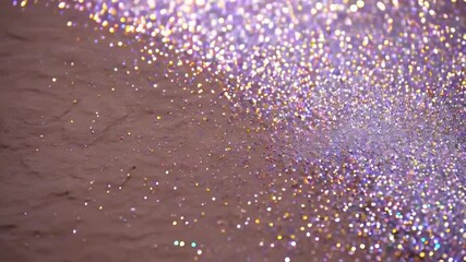 Poster - Lavender glitter cascading across a textured surface, creating a dazzling, shimmering effect with depth and highlights in various colors.