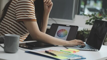 UX/UI designer working on wireframes for a website and mobile app prototype, surrounded by sketches of user-flow and design tools, in concept of website and mobile application design concept.