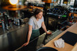 © Zamrznuti tonovi - Tired bartender leaning on bar counter in empty pub