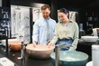 © Serhii - Couple exploring modern bathroom fixtures in store