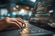© whitestorm - Close-up of a programmer coding on a laptop with code on the screen, and hands typing. Depicts software development and technology in a modern workspace setting.