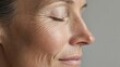 © Newleks - Senior woman's serene profile revealing deeply etched wrinkles, capturing graceful aging and timeless beauty of mature skin with soft shadows and tender details