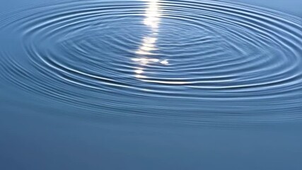 Poster - Sunlight reflecting on rippling water surface creating concentric circles, smooth blue liquid texture, and circular wave patterns on serene environment