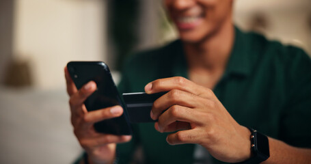 Poster - Credit card, phone and hands of man on sofa for online shopping, digital payment or fintech. Internet banking, account password and customer purchase with closeup of person in living room of home